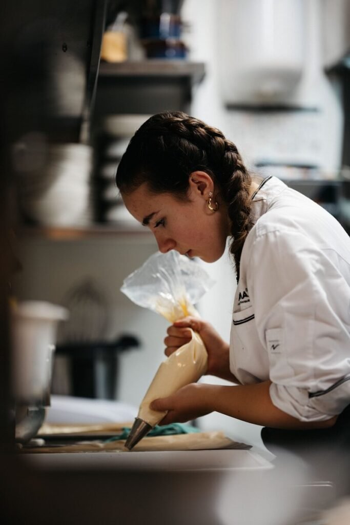 A woman in a kitchen preparing food on a cutting board